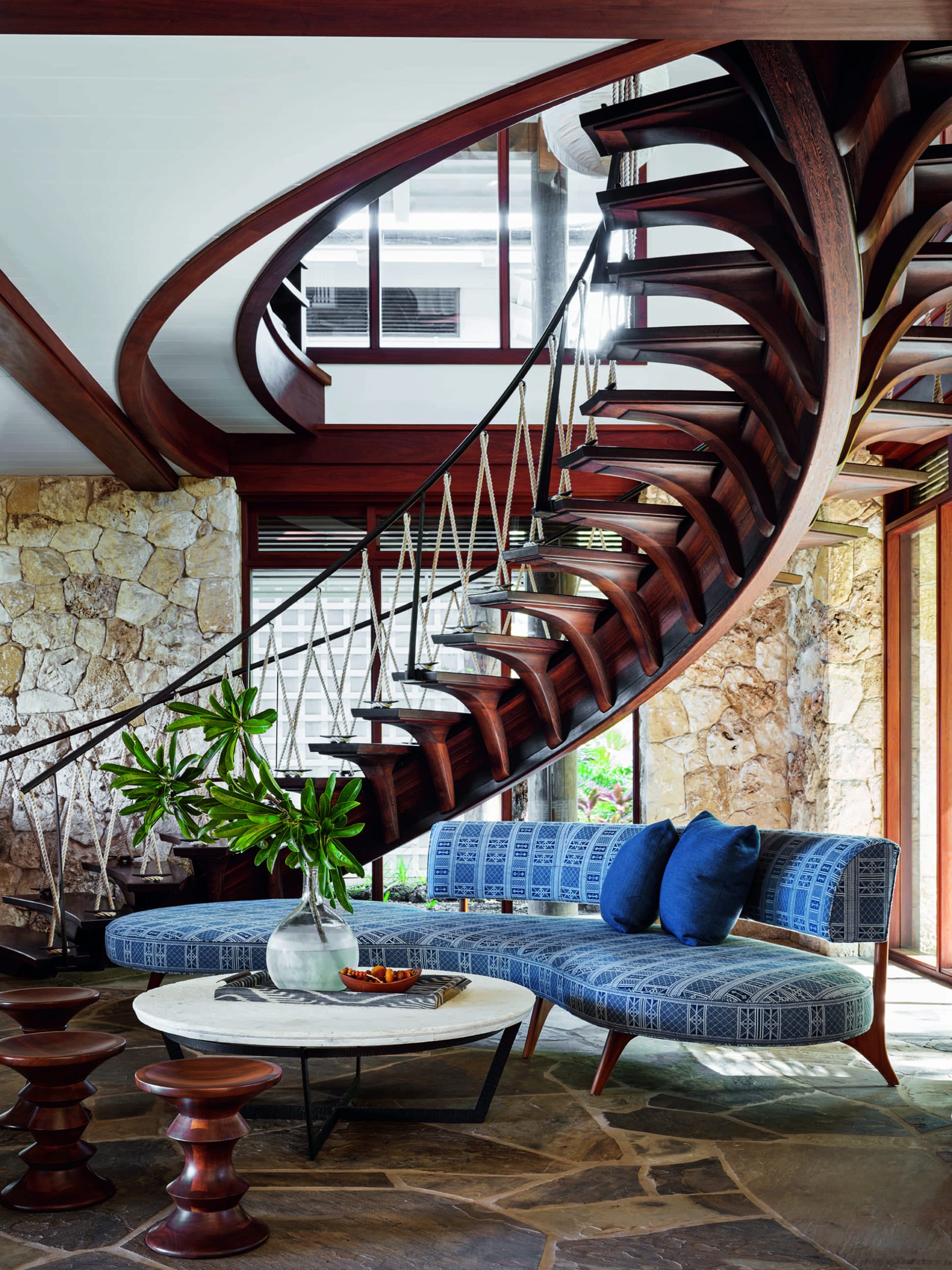 Carved wooden spiral staircase at a kite surfer's Hawaii estate. Interior by Martyn Lawrence Bullard.